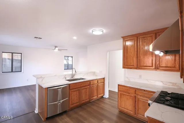 a kitchen with a sink stove and cabinets