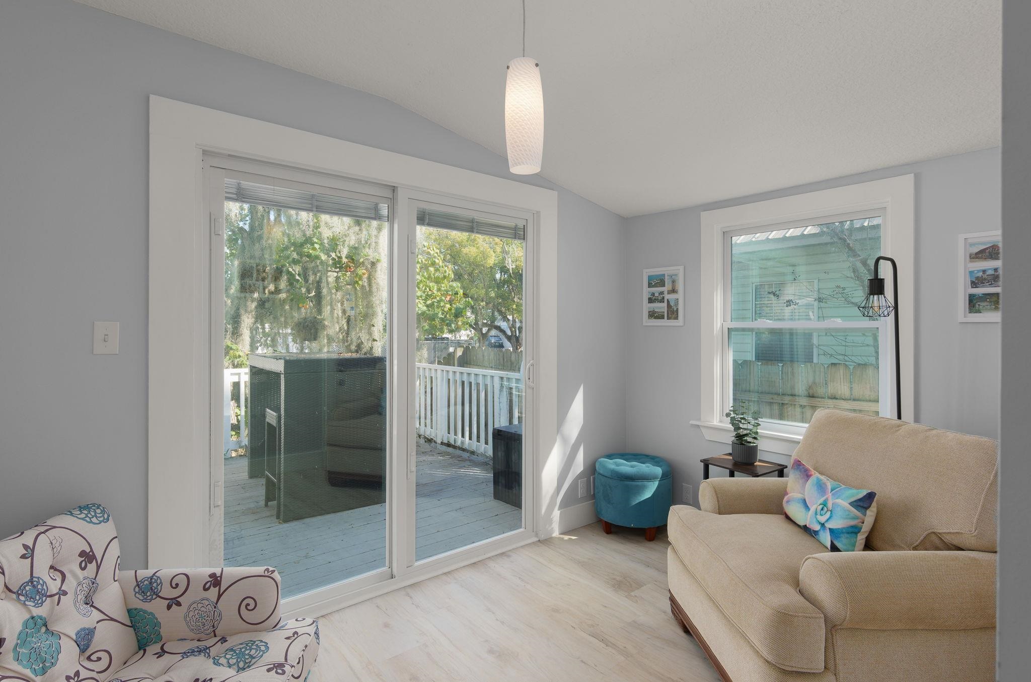 2 Clark Street St. Augustine, FL 32084 - Photo 12 of 39 a living room with furniture and a floor to ceiling window