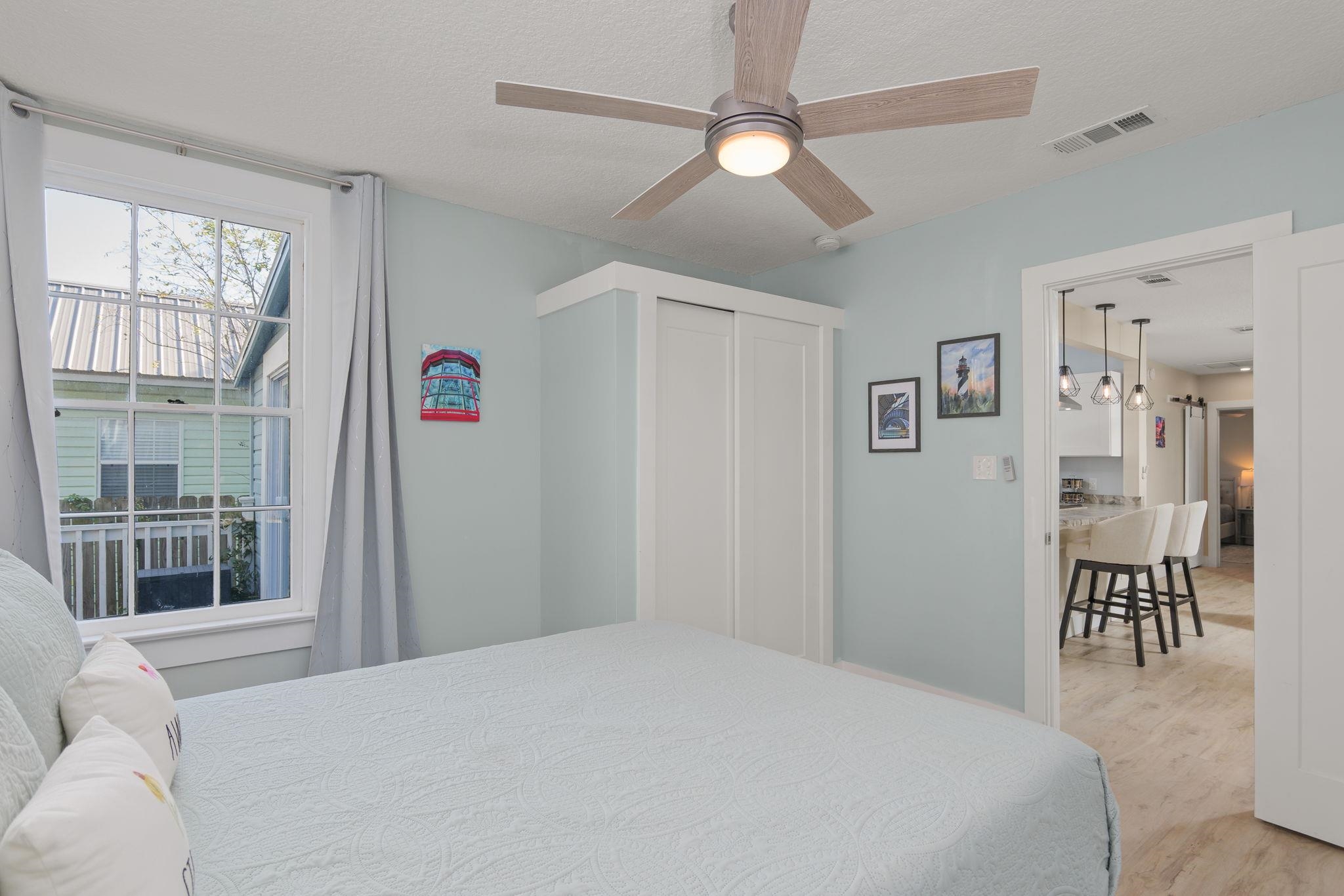 2 Clark Street St. Augustine, FL 32084 - Photo 13 of 39 a bedroom with a large bed and a chandelier
