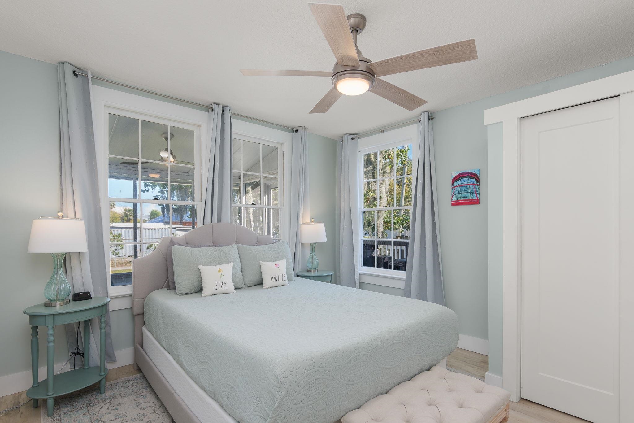 2 Clark Street St. Augustine, FL 32084 - Photo 14 of 39 a bedroom with a large bed and a chandelier