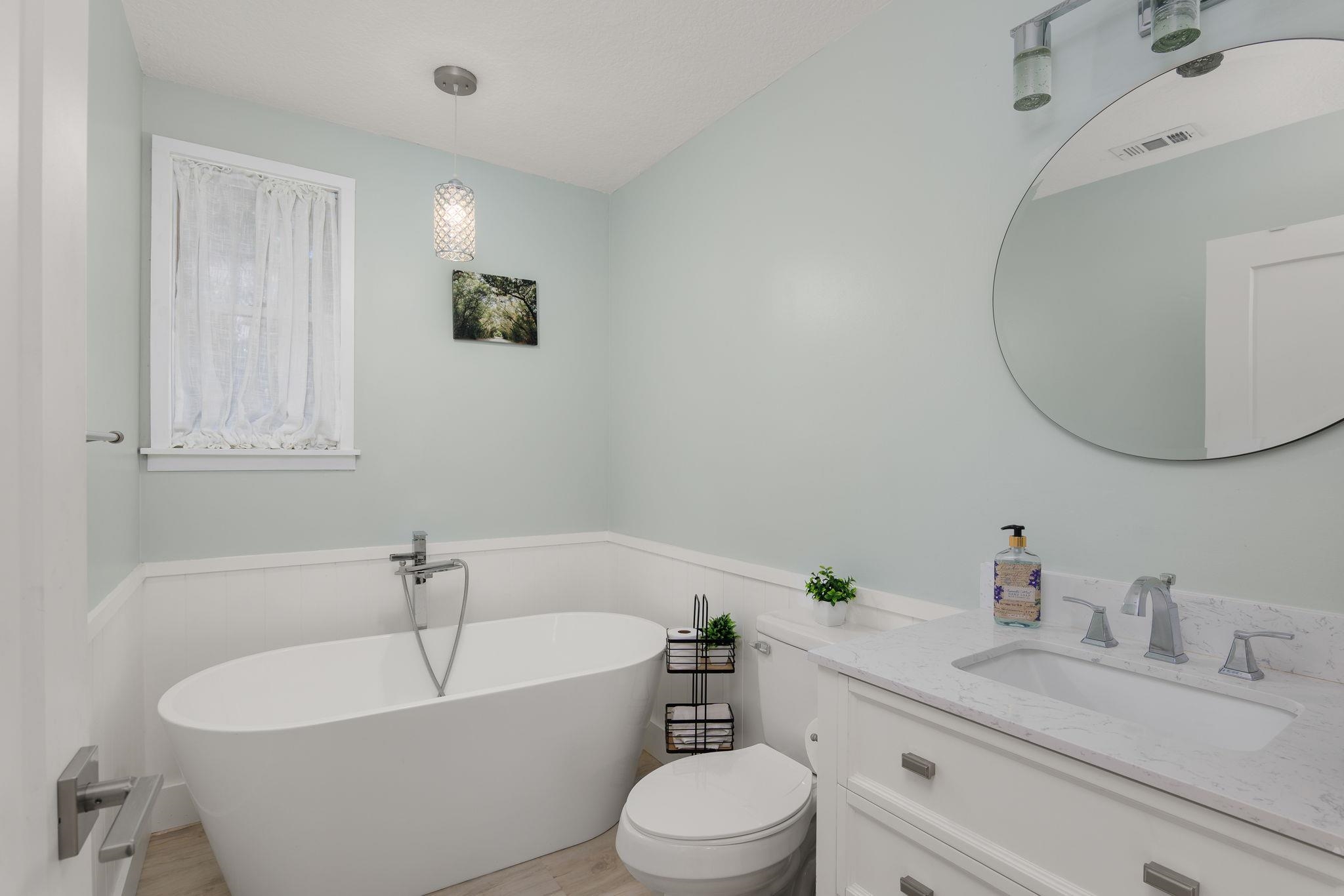 2 Clark Street St. Augustine, FL 32084 - Photo 15 of 39 a bathroom with a white tub a sink and a mirror