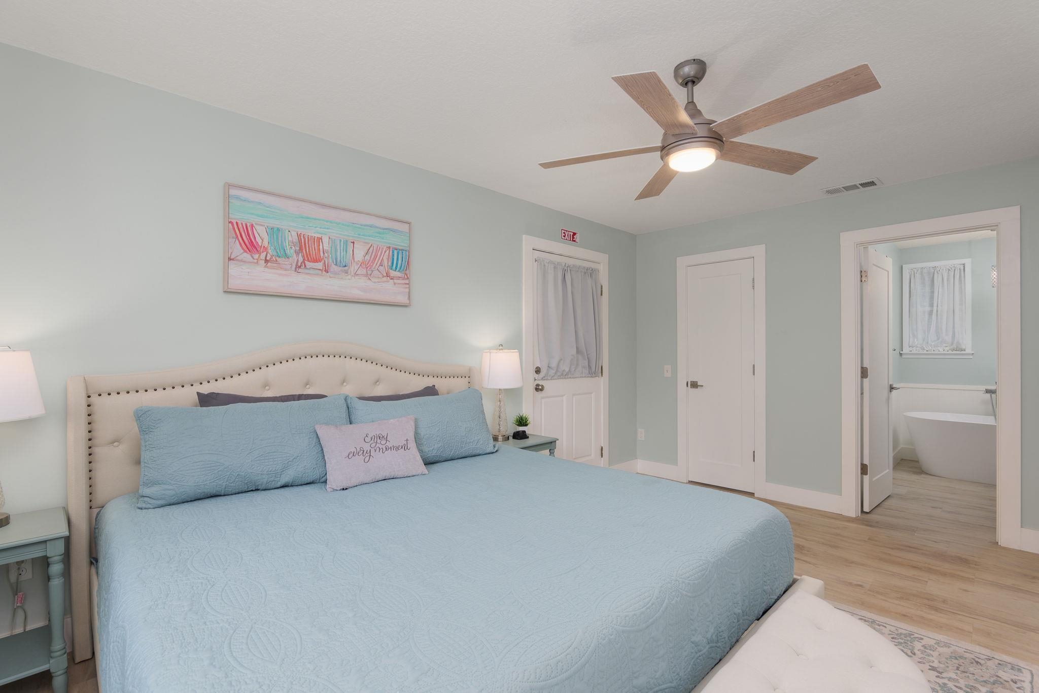 2 Clark Street St. Augustine, FL 32084 - Photo 18 of 39 a bedroom with a large bed and a chandelier