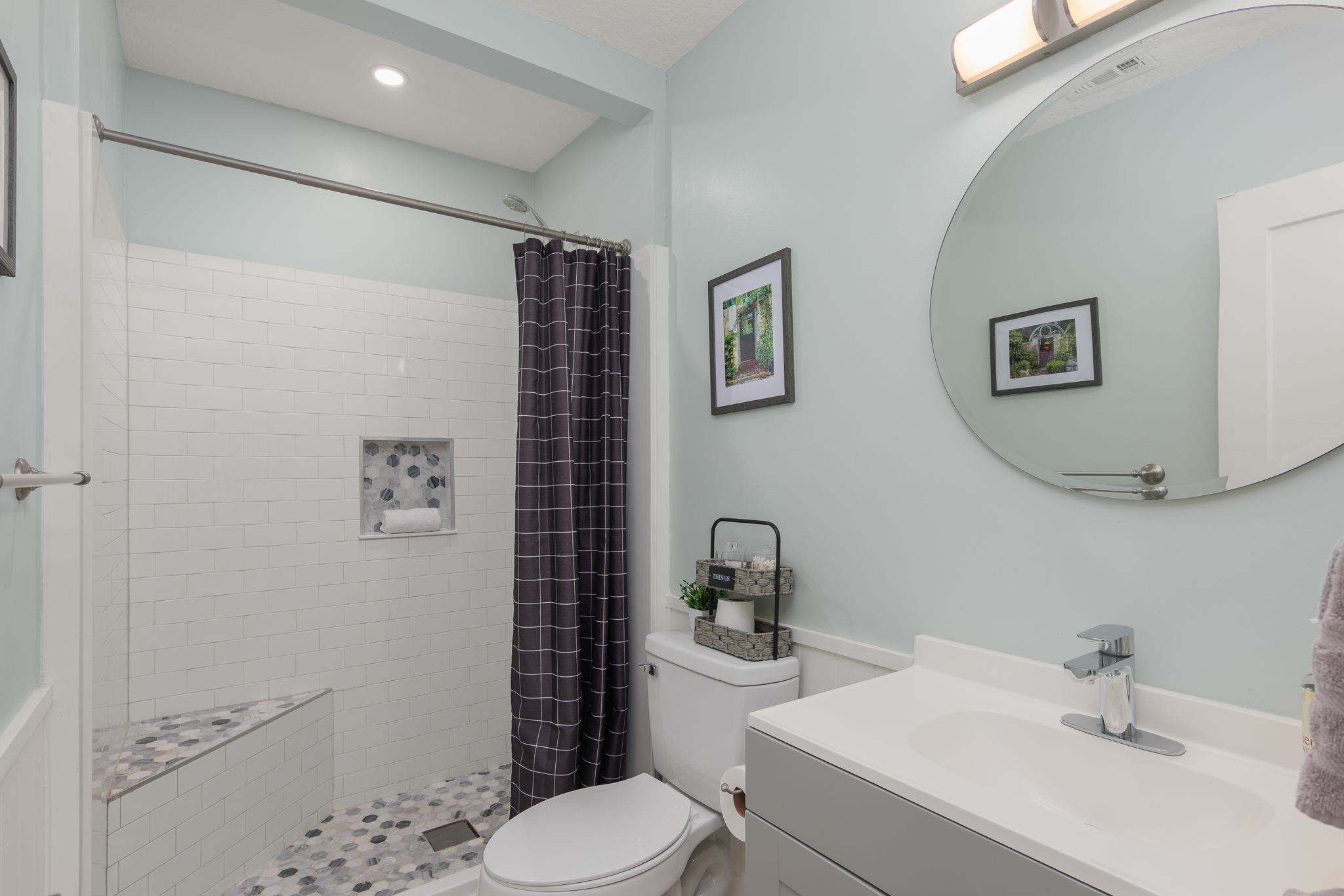 2 Clark Street St. Augustine, FL 32084 - Photo 20 of 39 a bathroom with a toilet sink and mirror