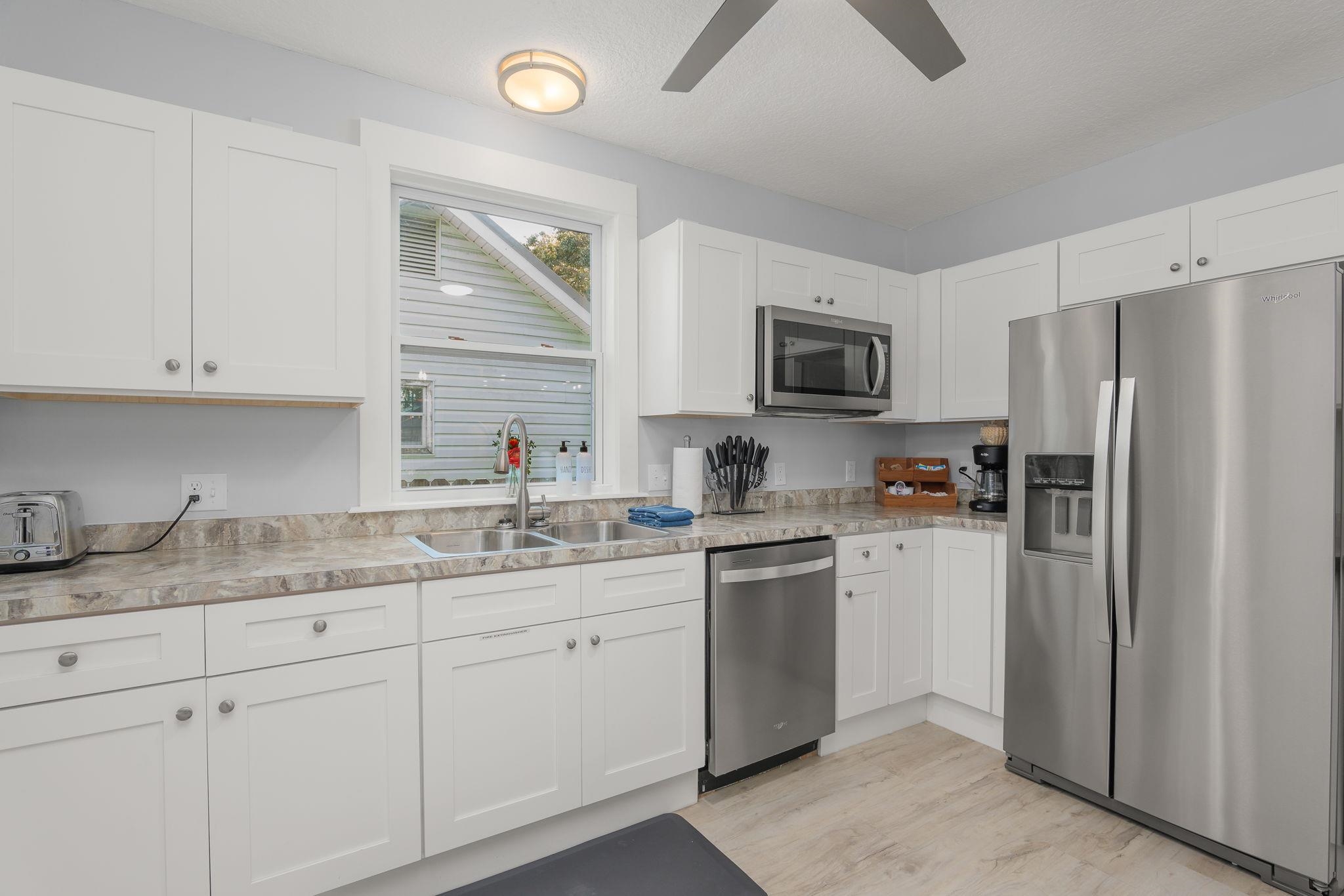 2 Clark Street St. Augustine, FL 32084 - Photo 8 of 39 a kitchen with a sink cabinets and stainless steel appliances