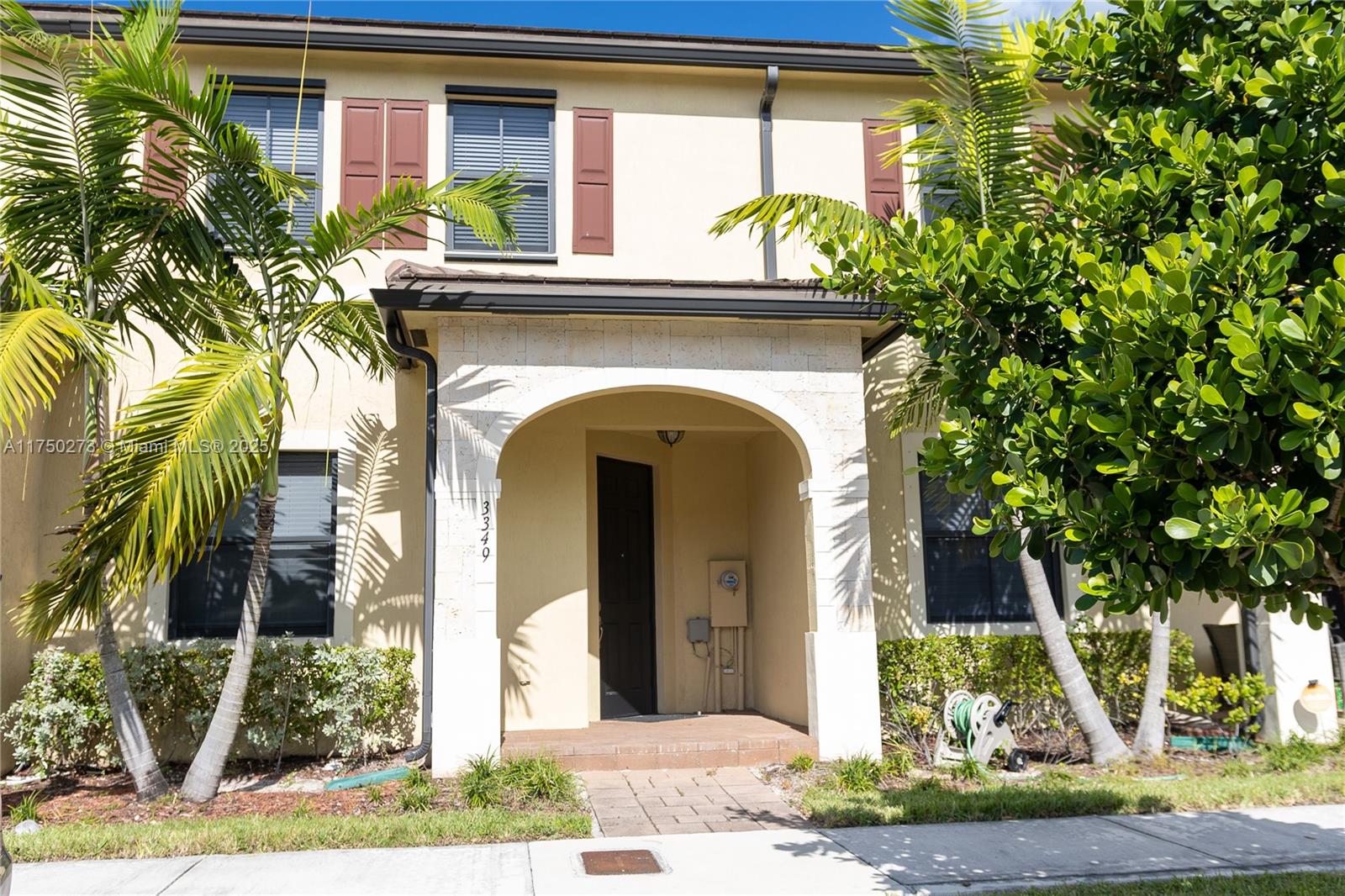 3349 West 105th Terrace, Unit 3349 Hialeah, FL 33018 - Photo 2 of 11 a front view of a house with garden