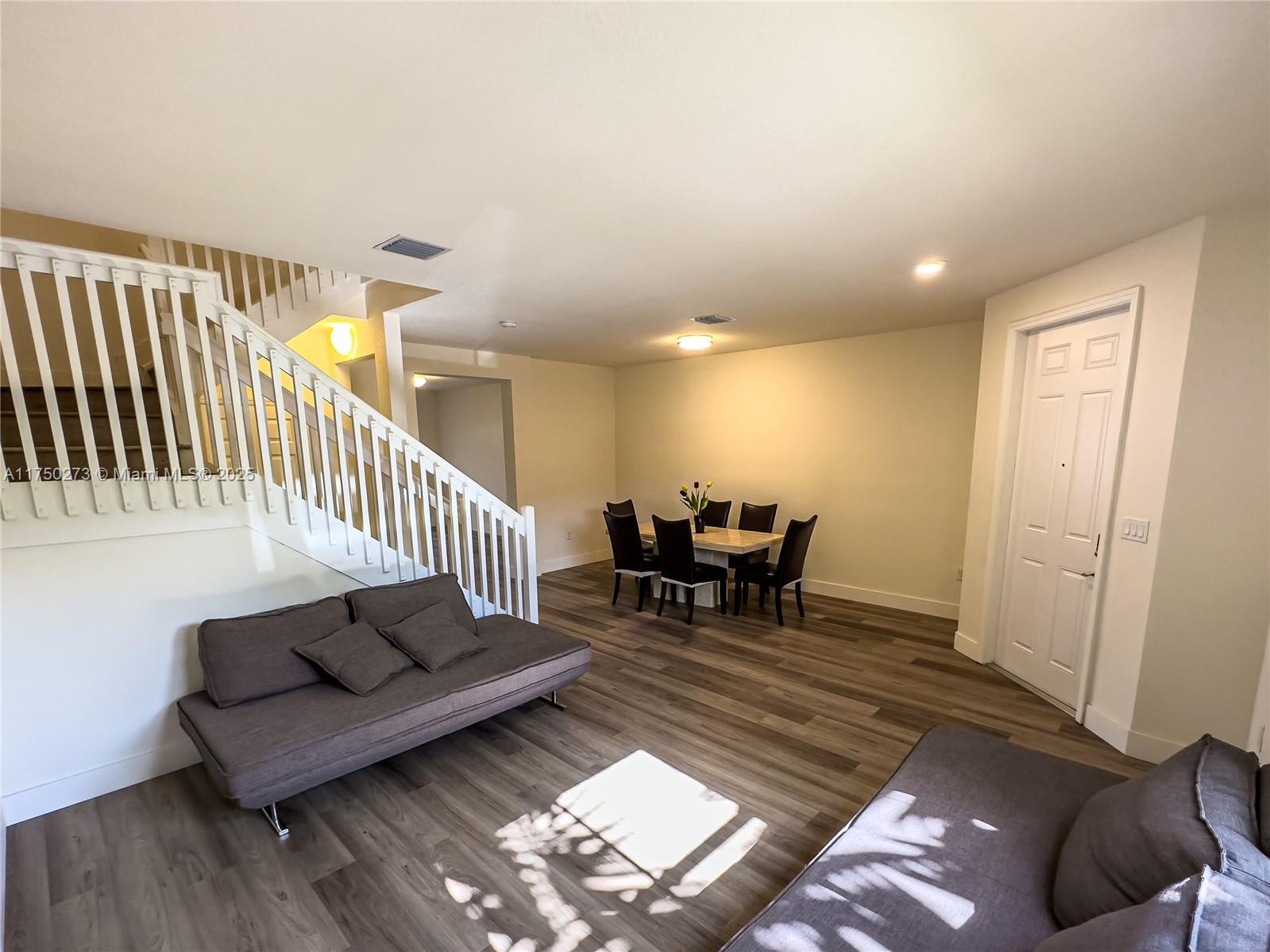 3349 West 105th Terrace, Unit 3349 Hialeah, FL 33018 - Photo 3 of 11 a living room with furniture and a rug