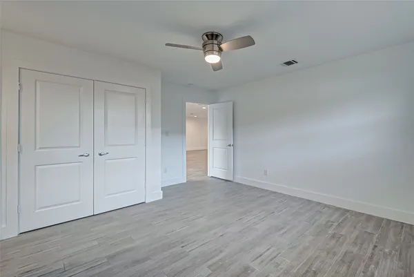 a view of an empty room and wooden floor