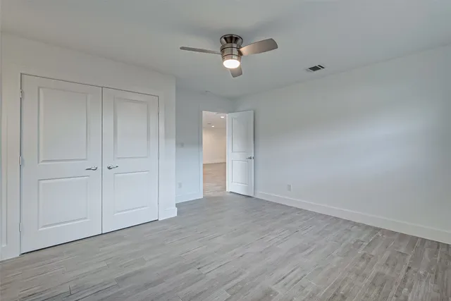 a view of an empty room and wooden floor