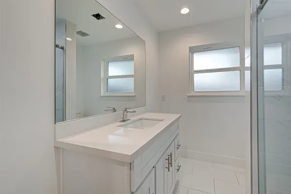 a bathroom with a sink a vanity and a mirror