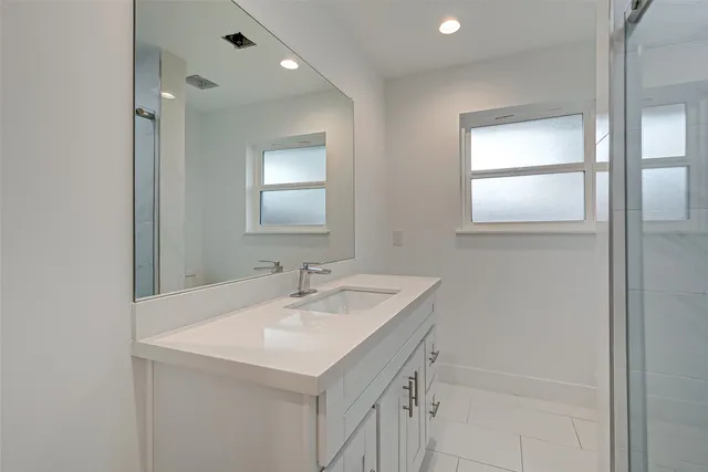 a bathroom with a sink a vanity and a mirror