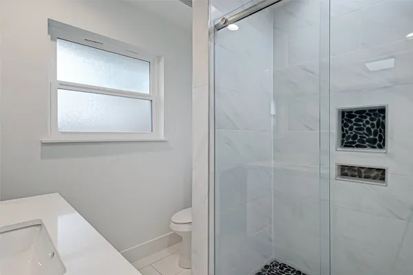 a bathroom with a toilet and a shower