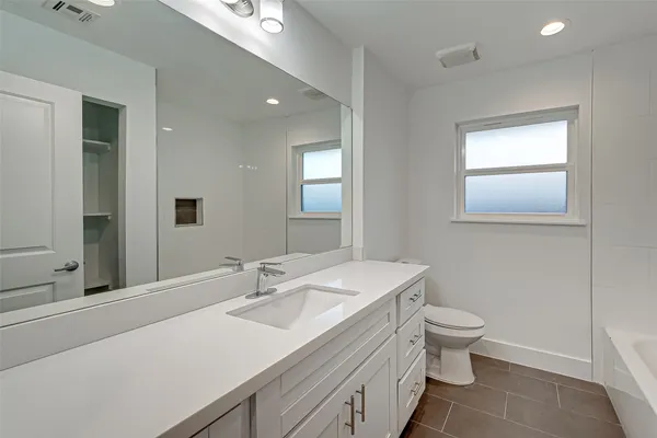 a bathroom with a sink toilet and mirror
