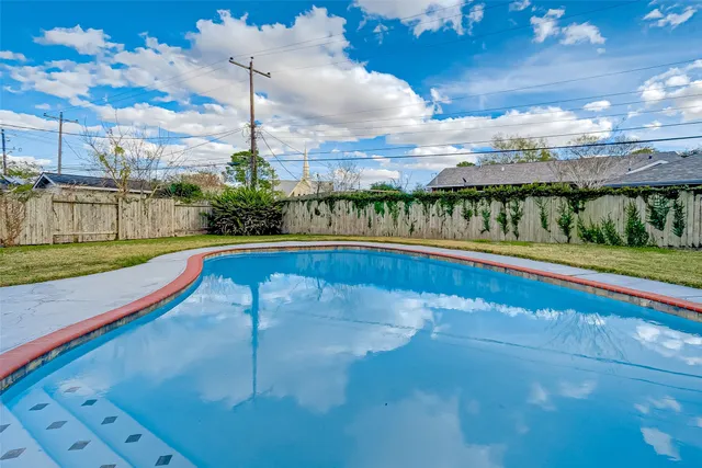 a view of a swimming pool with an outdoor seating