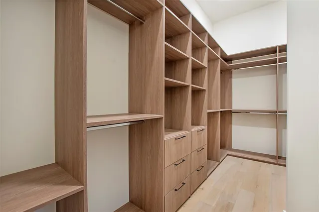 a view of walk in closet with empty racks