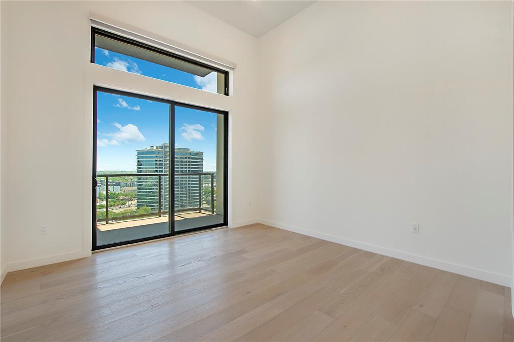 2620 Maple Avenue, Unit 1101 Dallas, TX 75201 - Photo 18 of 39 an empty room with wooden floor and sliding door