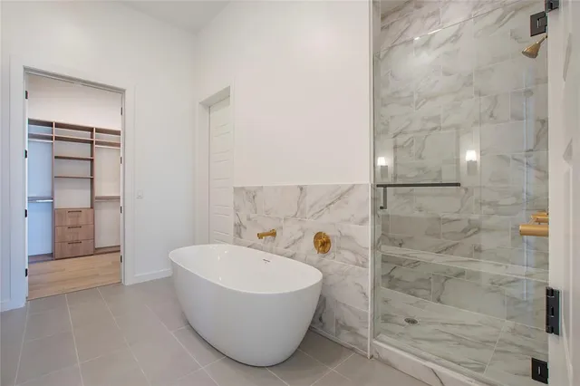 a bathroom with a bathtub and shower