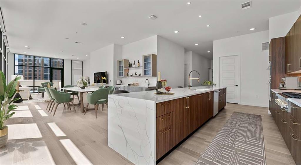2620 Maple Avenue, Unit 1101 Dallas, TX 75201 - Photo 2 of 39 a large kitchen with stainless steel appliances a large counter top a sink a stove and a refrigerator