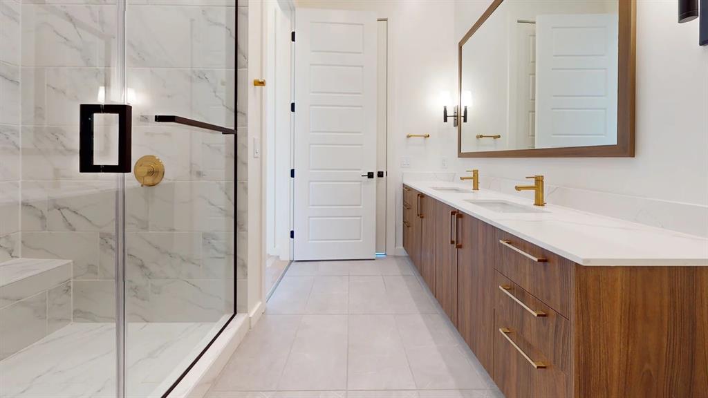 2620 Maple Avenue, Unit 1101 Dallas, TX 75201 - Photo 23 of 39 a bathroom with a double vanity sink and mirror