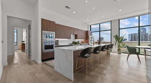 a kitchen with a table chairs refrigerator and cabinets
