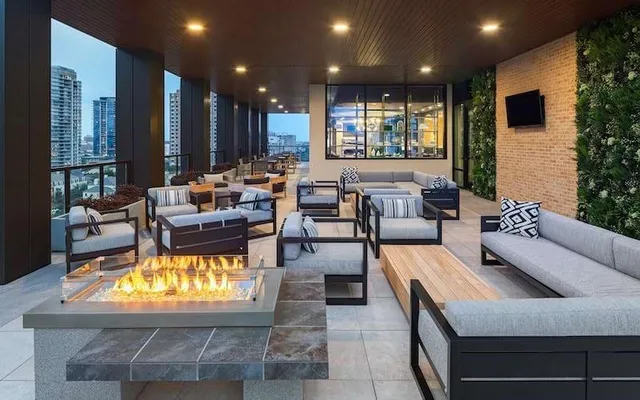 a view of a patio with couches and table and chairs and potted plants