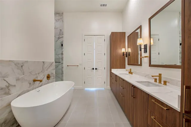 a spacious bathroom with a double vanity sink mirror and double
