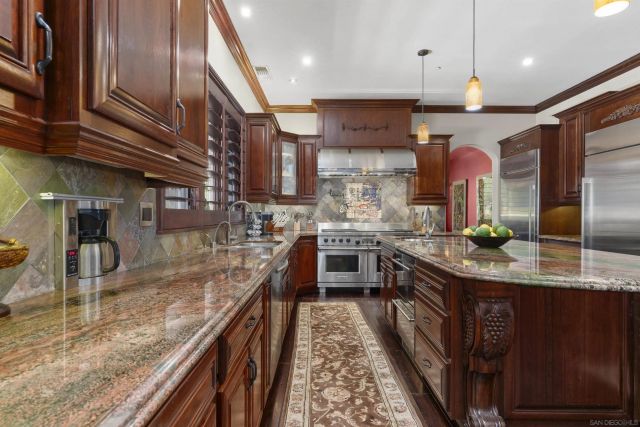 a bathroom with a granite countertop toilet and a sink
