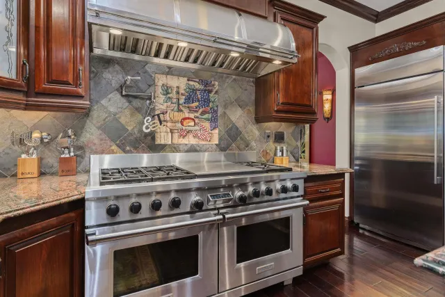 a spacious bathroom with a granite countertop shower a sink and a stove