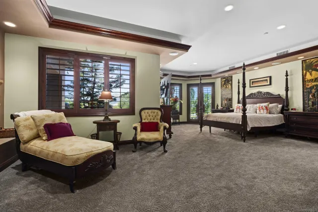 a view of a lush green field with mountains in the background