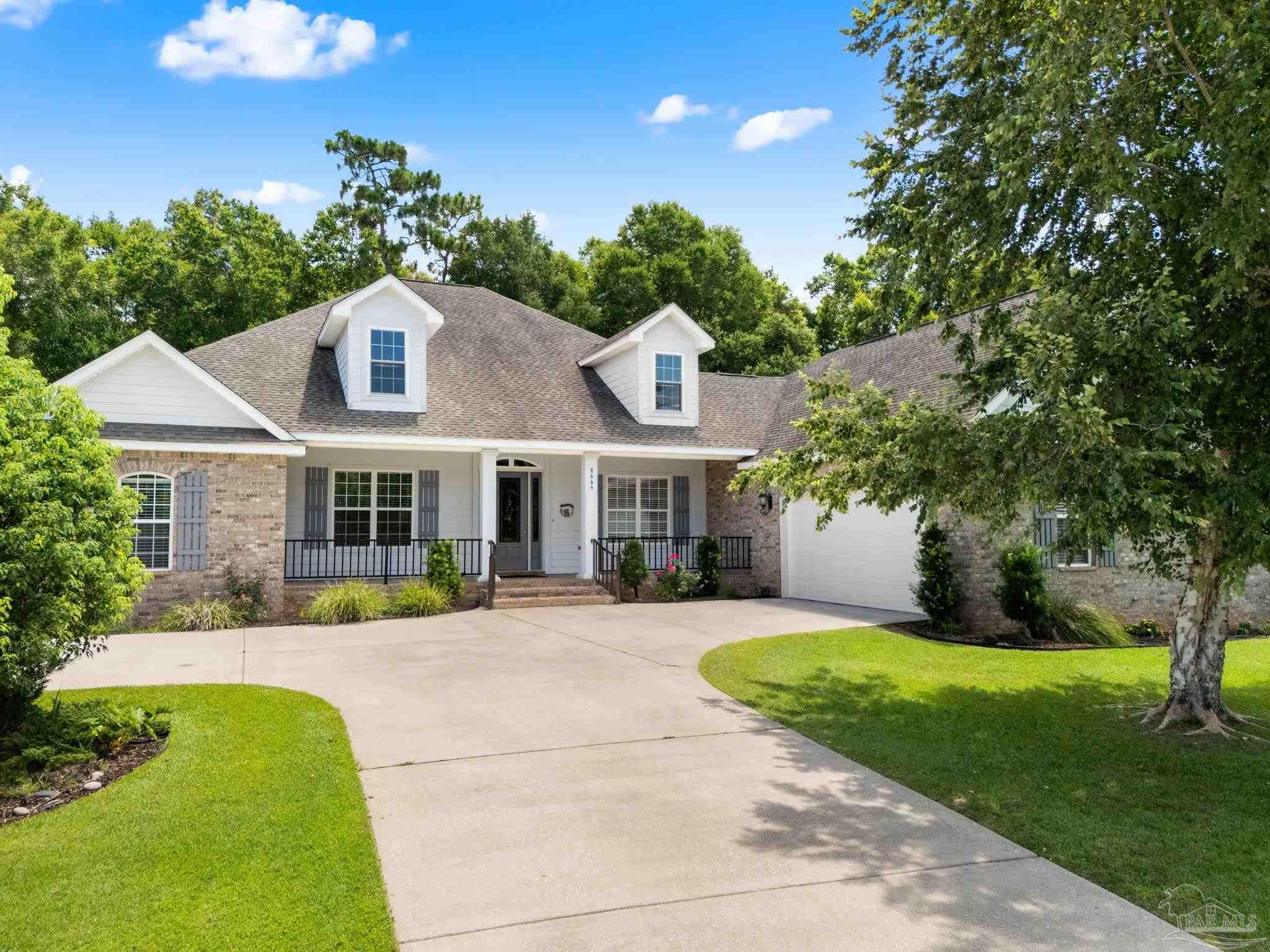 8664 Foxtail Loop Pensacola, FL 32526 - Photo 13 of 46 a front view of a house with a yard table and chairs
