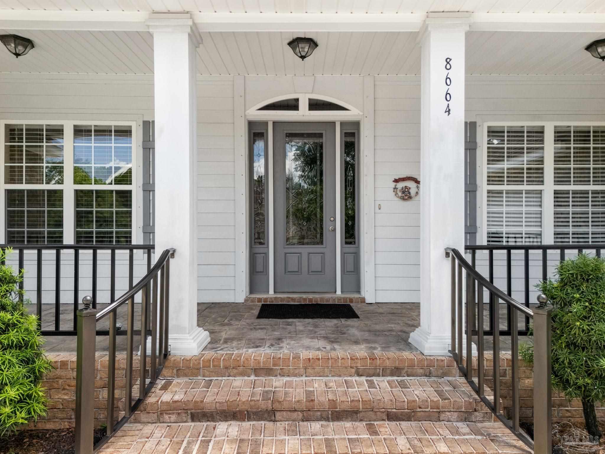 8664 Foxtail Loop Pensacola, FL 32526 - Photo 14 of 46 a front view of a house with a porch