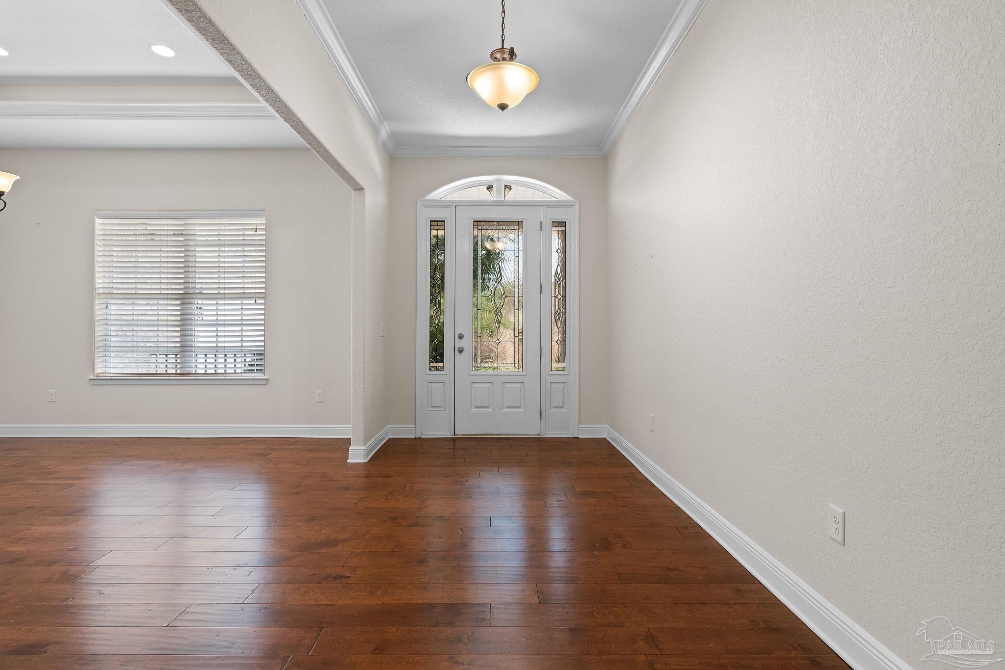 8664 Foxtail Loop Pensacola, FL 32526 - Photo 15 of 46 an empty room with wooden floor fan and windows