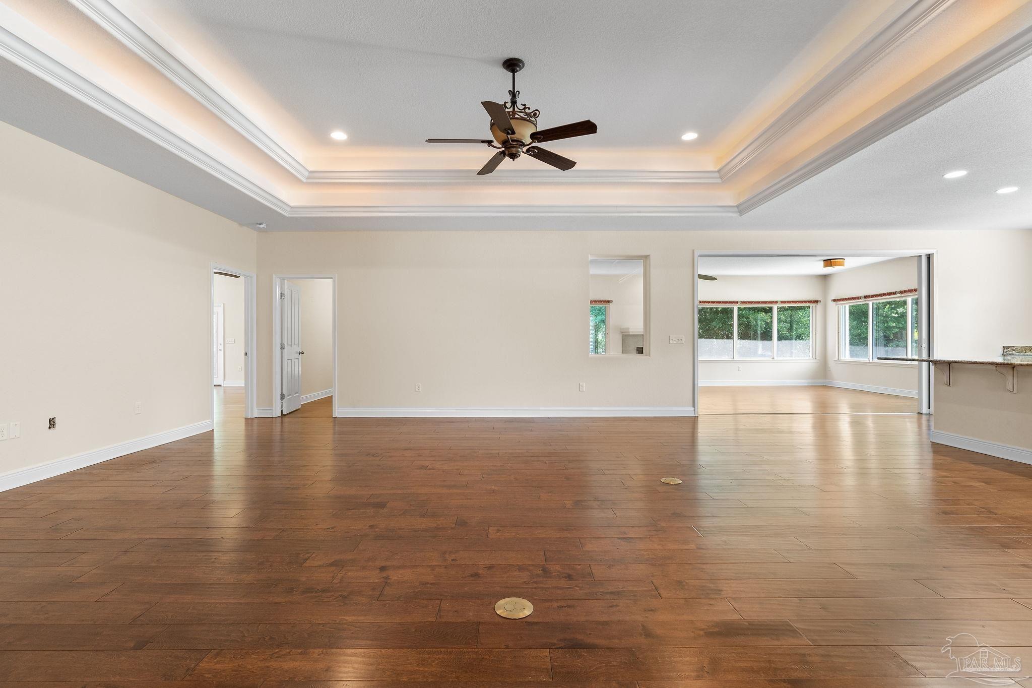 8664 Foxtail Loop Pensacola, FL 32526 - Photo 17 of 46 a view of an empty room with window and wooden floor
