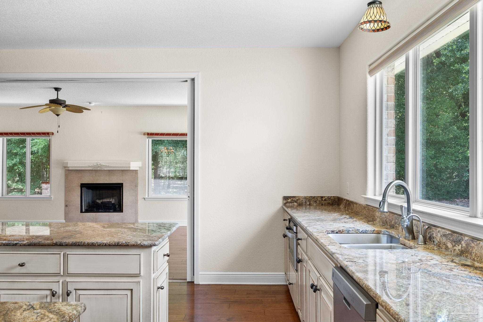 8664 Foxtail Loop Pensacola, FL 32526 - Photo 23 of 46 a kitchen with granite countertop a sink and a stove