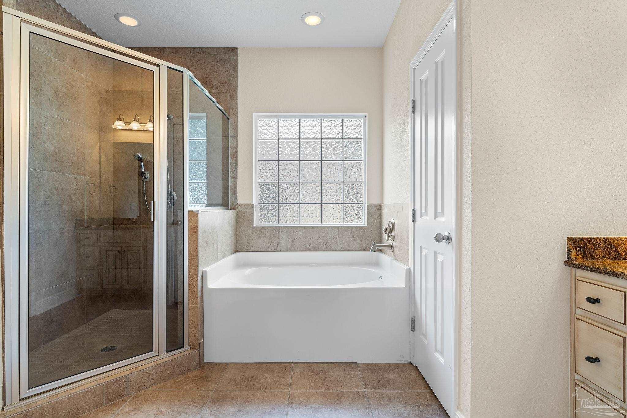 8664 Foxtail Loop Pensacola, FL 32526 - Photo 29 of 46 a bathroom with a bathtub and a shower