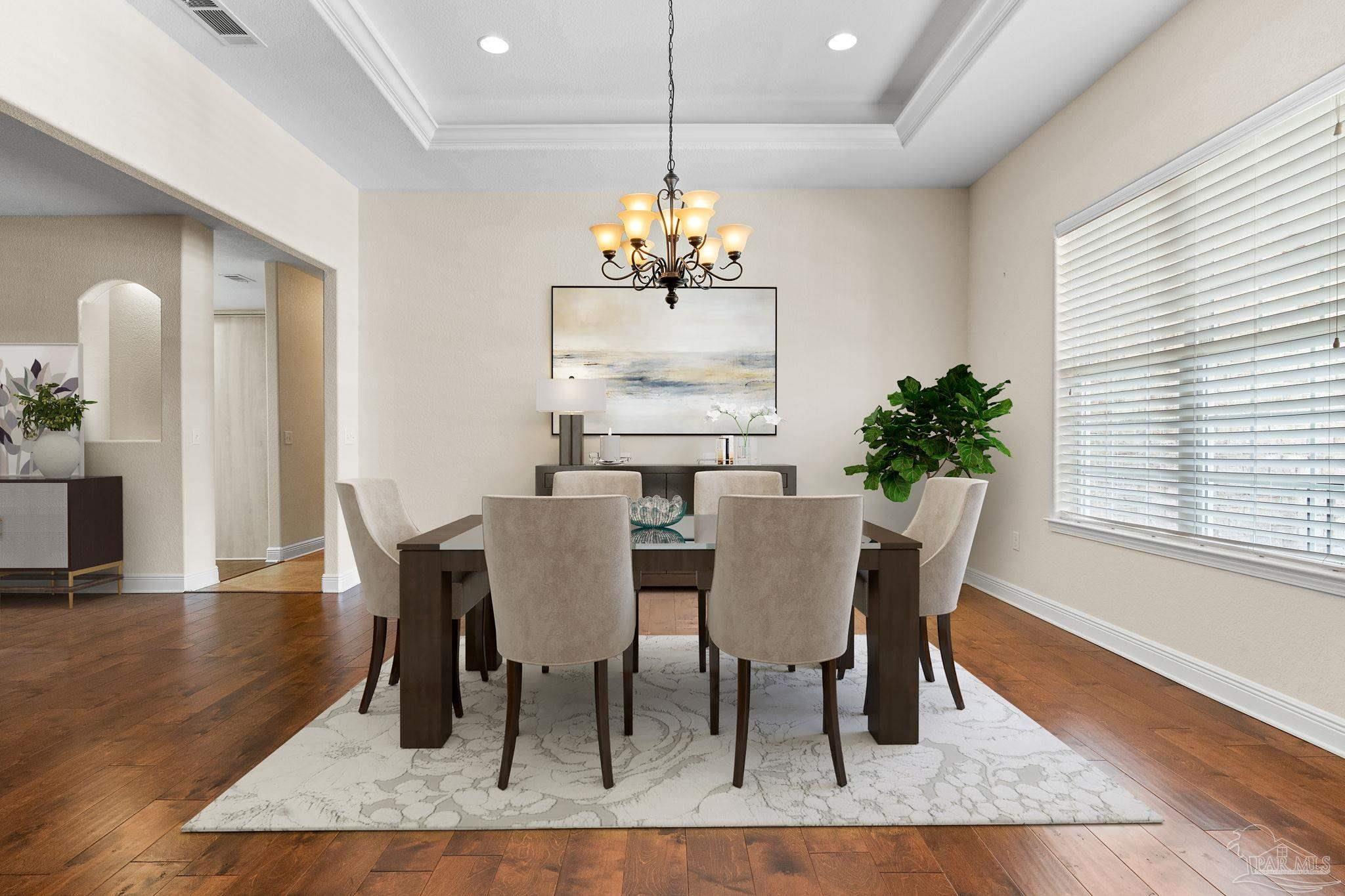 8664 Foxtail Loop Pensacola, FL 32526 - Photo 3 of 46 a view of a dining room with furniture window and wooden floor