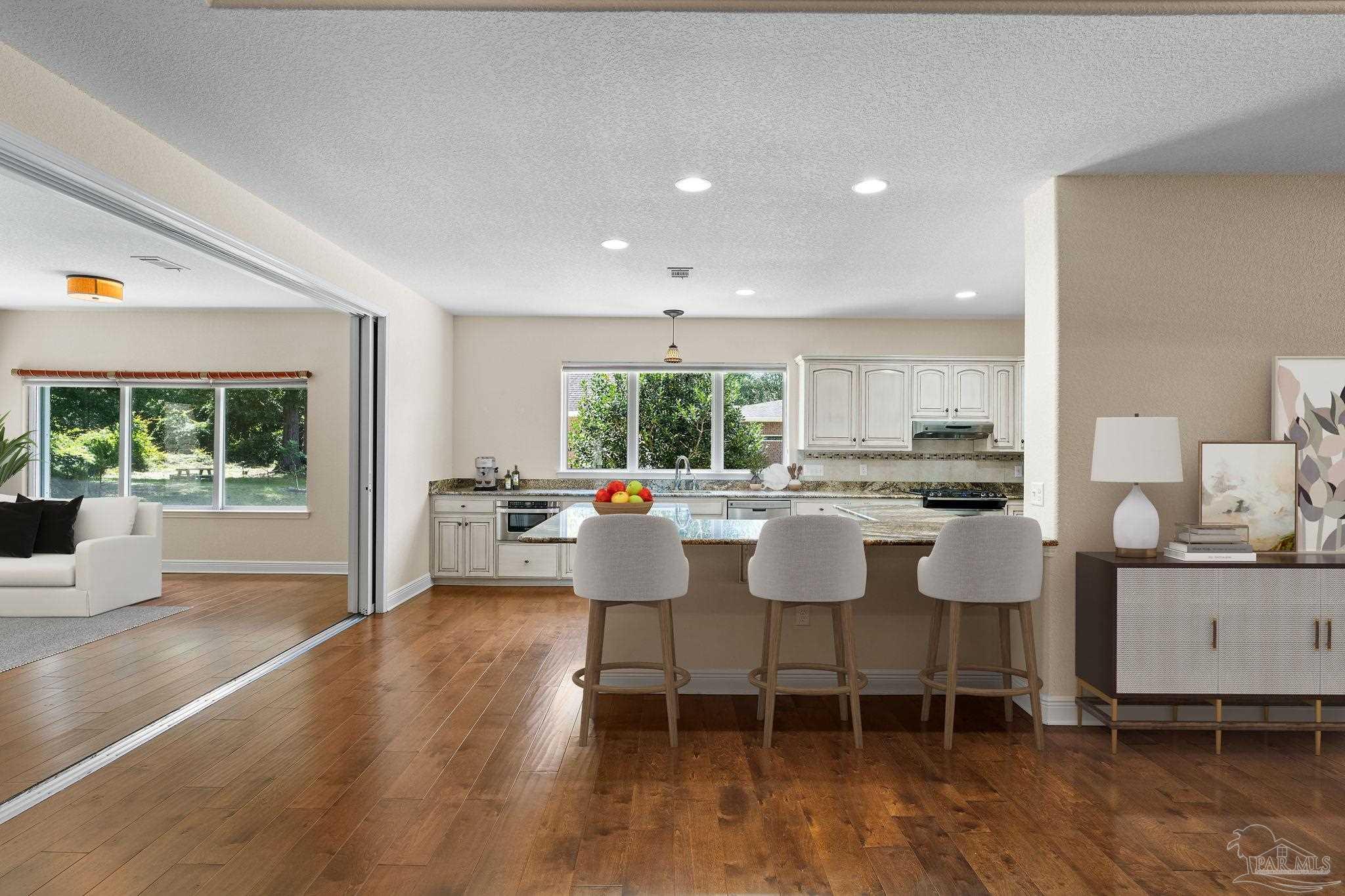 8664 Foxtail Loop Pensacola, FL 32526 - Photo 5 of 46 a dining room with wooden floor and a table