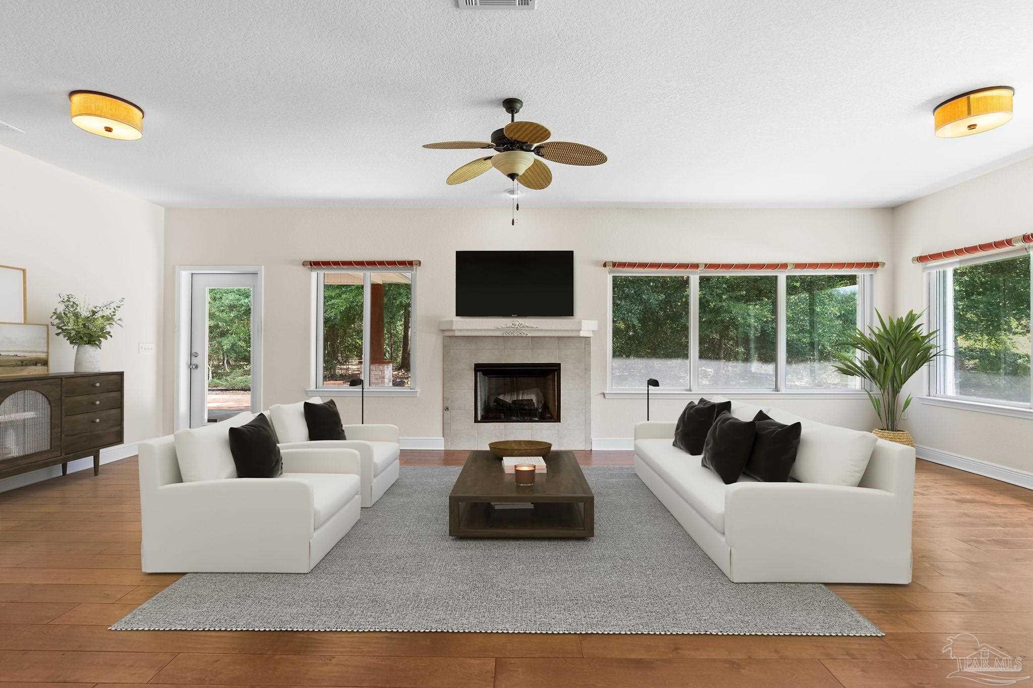 8664 Foxtail Loop Pensacola, FL 32526 - Photo 7 of 46 a living room with furniture and a fireplace