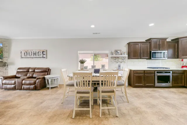 a large kitchen with stainless steel appliances granite countertop a stove and a sink