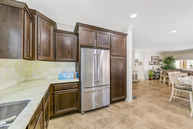 a kitchen with cabinets a sink and stainless steel appliances