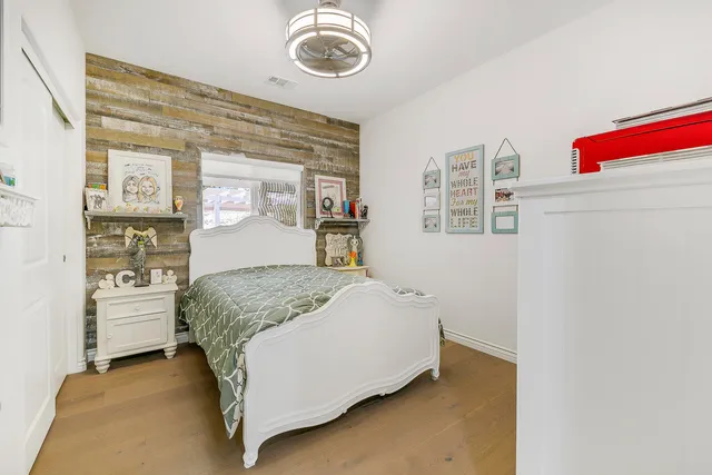 a bedroom with a bed and a chandelier