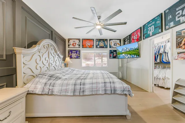 a bed sitting in a bedroom next to a window