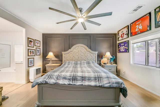 a bedroom with a bed and a chandelier