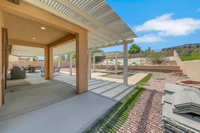 a view of a house with backyard and sitting area
