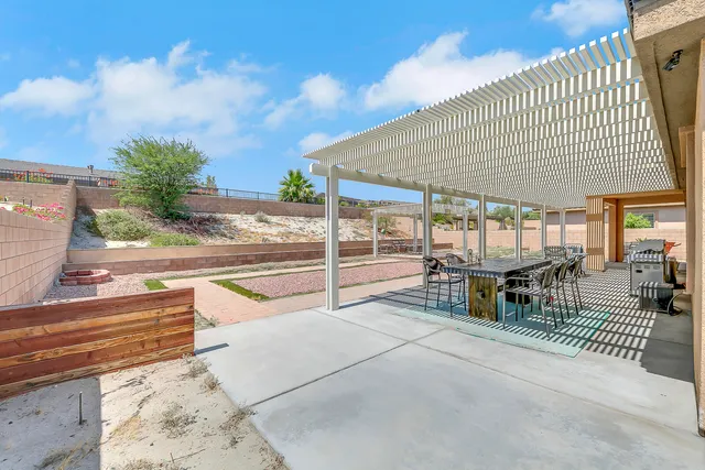 a dining room with a wooden table and chairs