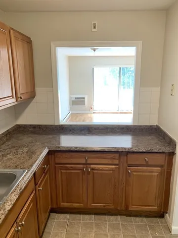a kitchen with granite countertop a sink and cabinets