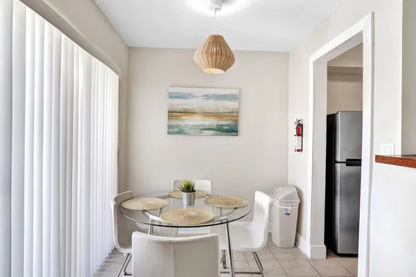 a room with white cabinets and chairs