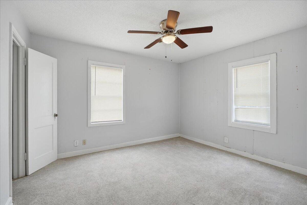 2503 30th Street Lubbock, TX 79410 - Photo 17 of 26 an empty room with a window and a ceiling fan