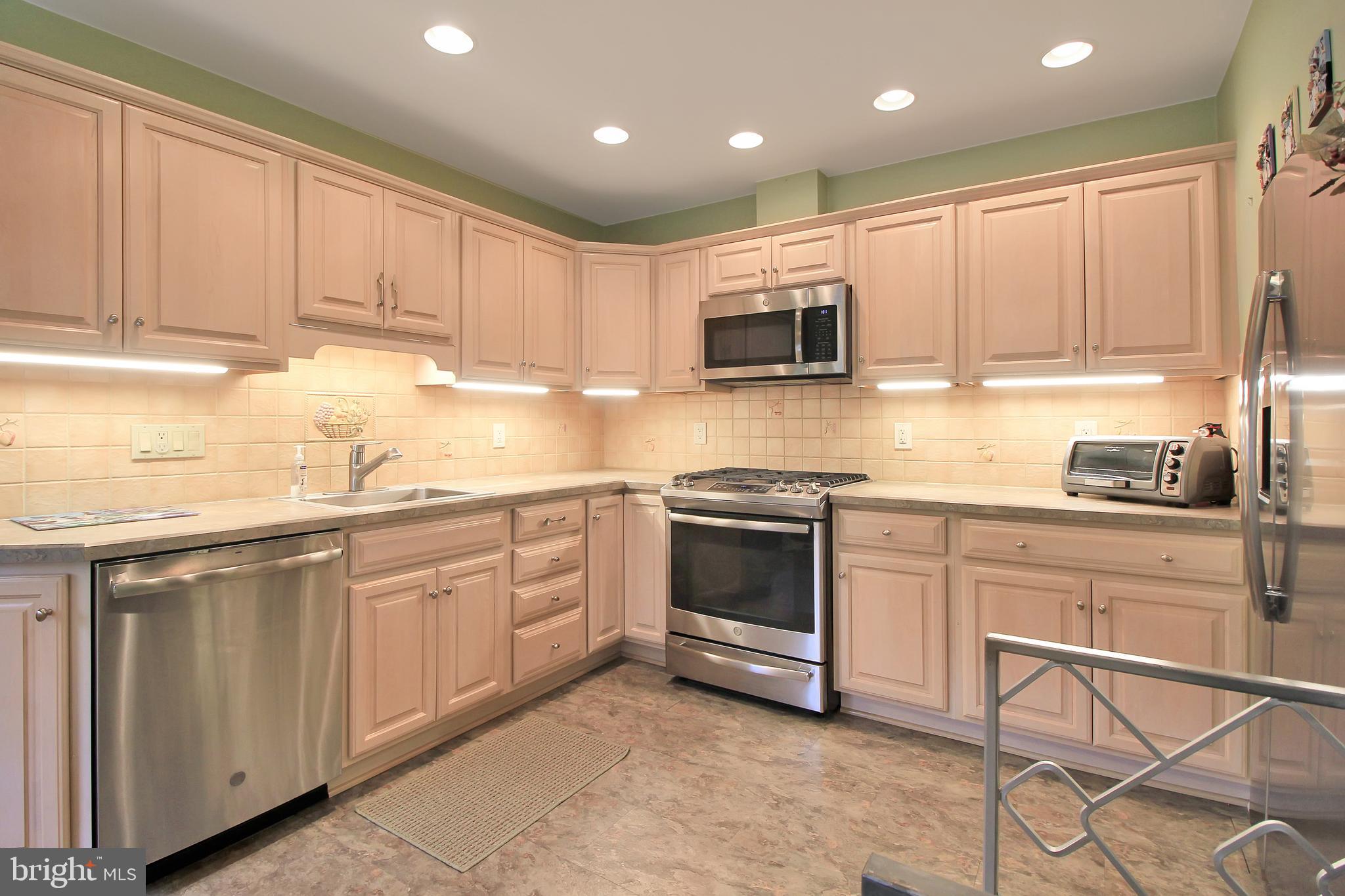 9702 Wynmill Road Philadelphia, PA 19115 - Photo 12 of 35 a kitchen with granite countertop a sink stainless steel appliances and cabinets