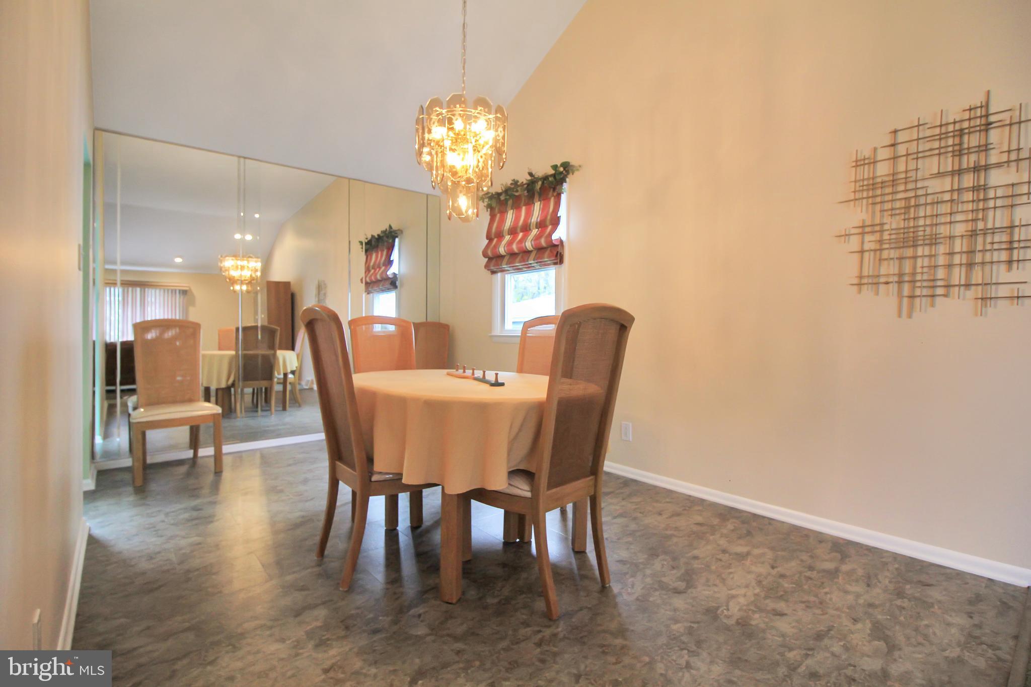 9702 Wynmill Road Philadelphia, PA 19115 - Photo 19 of 35 a view of a dining room with furniture and chandelier