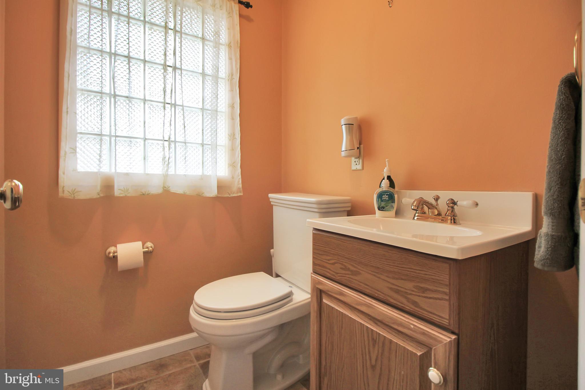 9702 Wynmill Road Philadelphia, PA 19115 - Photo 26 of 35 a bathroom with a sink a toilet and a mirror